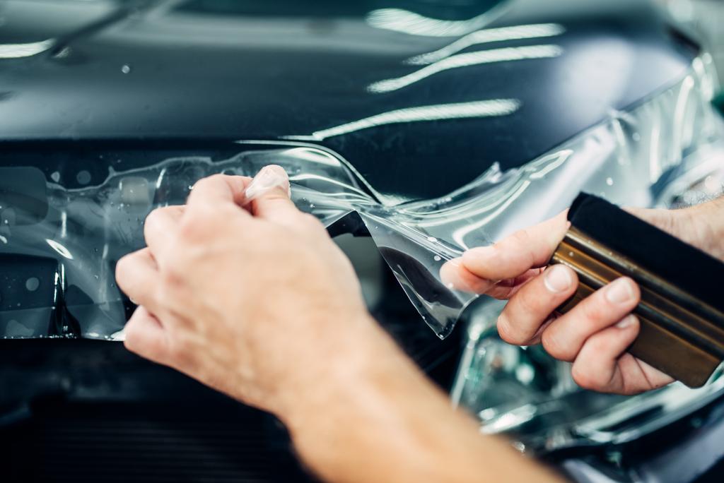 stock photo worker installing car protection film